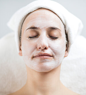 Woman relaxes while enjoying a face mask