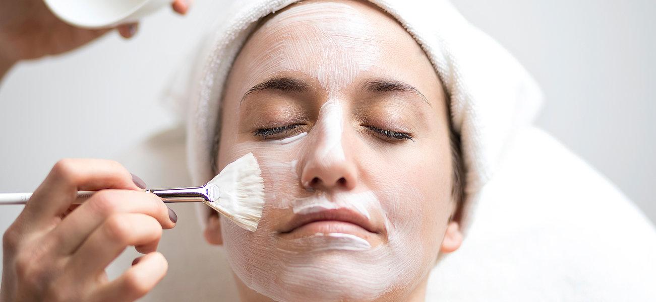 Face mask being applied with a paintbrush