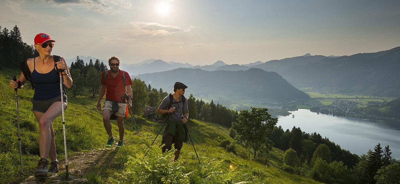 Dreiergruppe wandert mit Aussicht auf den Walchsee